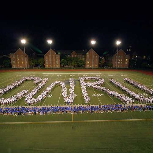 Over 1600 students gather on DiSanto Field in white and blue t-shirts to form the letters C-W-R-U.