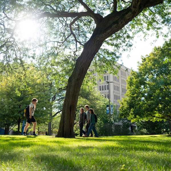 CWRU students walking through Case Quad on a sunny day. 