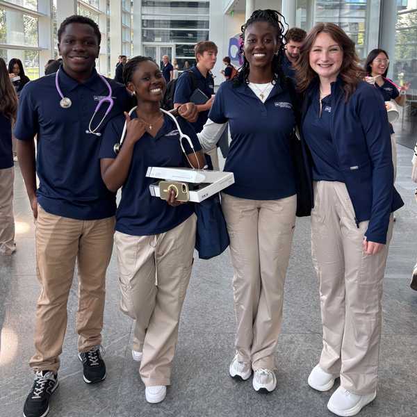 Four first-year BSN students pose with their stethoscopes at the Health Education Campus. 